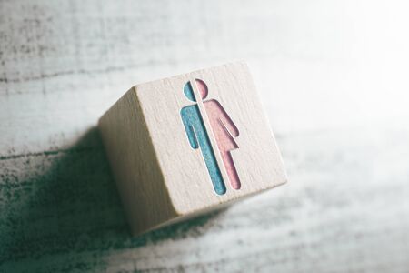 Gender Icons For Male And Female Cut In Half On Wooden Block On A Tableの写真素材