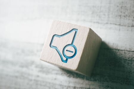 Volume Down Icon On Wooden Block On A Tableの写真素材