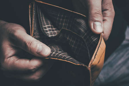 Man Showing His Empty Wallet - No Money Left Concept