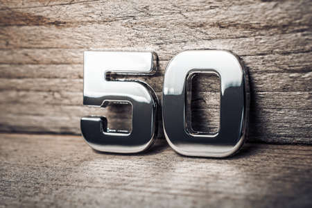 Chrome Number 50 Leaning On A Wooden Wallの写真素材