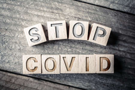Stop Covid Written On Wooden Blocks On A Boardの写真素材
