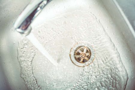 Water Jet Streaming In The Sink And Down The Drainの写真素材