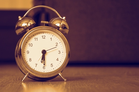 Classic alarm clock on the floorの写真素材