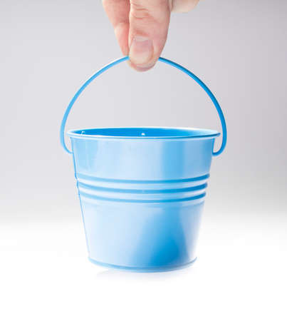 Hand holding small bucketの写真素材