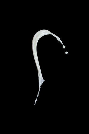 splash of milk on black backgroundの写真素材