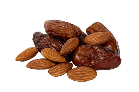 dates and almonds on a white backgroundの写真素材