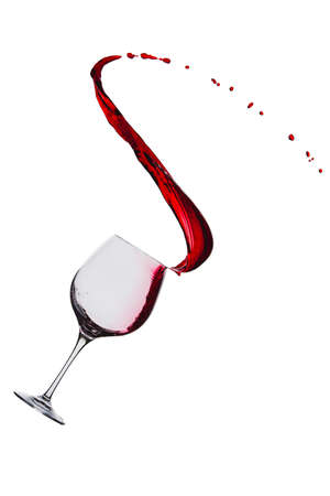 splash of red wine in a glass on a white backgroundの写真素材