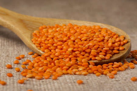 handful of red lentils on a background sackcloth