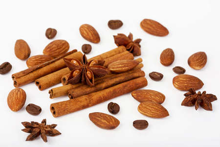 almonds coffee star anise and cinnamon on a white backgroundの写真素材