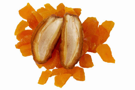 dates and sliced apricots on a white backgroundの写真素材
