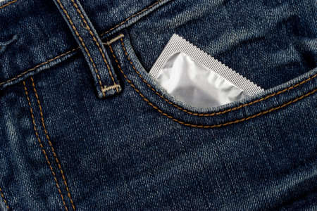 condom in package on a jeans clothの写真素材