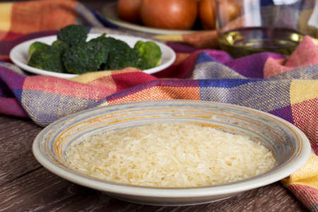 handful of rice grains in a plateの写真素材