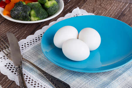 the white eggs in a blue plateの写真素材