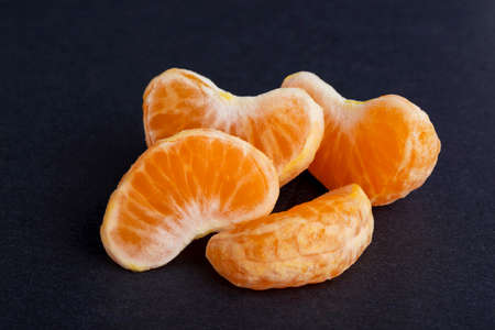 slices of mandarin on a black backgroundの写真素材