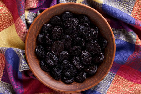 handful of prunes on a clay plateの写真素材
