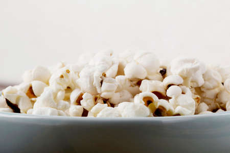 popcorn in a plate on the tableの写真素材