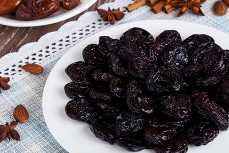 handful of prunes on a white plateの写真素材