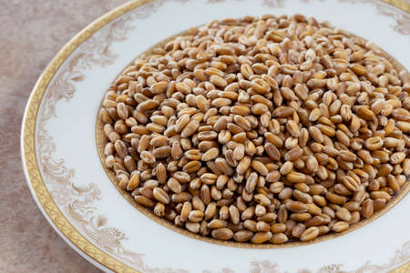 a handful of wheat in the plateの写真素材