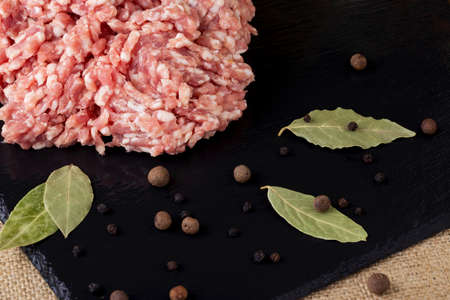 minced meat on a black cutting boardの写真素材