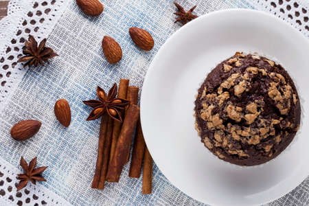 chocolate muffin in a white plate on the tableの写真素材