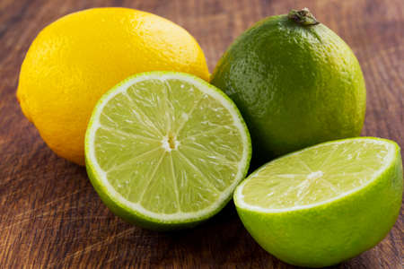 lemon and lime on a wooden tableの写真素材