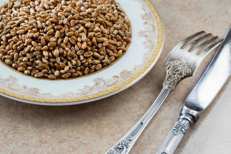 a handful of wheat in the plateの写真素材