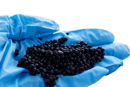 a handful of black caviar in hand