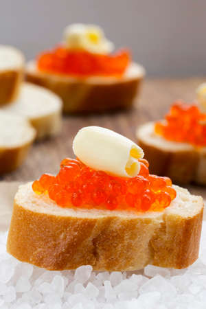 red caviar on a piece of breadの写真素材