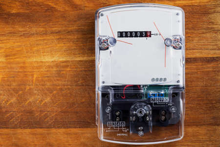 the electric meter on a wooden wallの写真素材