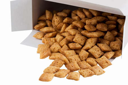 a handful of dry cereal in the shape of squares