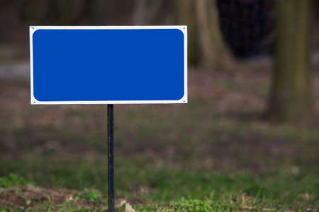 blue blank road sign on a blurred backgroundの写真素材