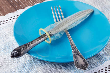 condom in a plate on the tableの写真素材