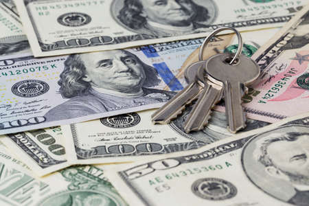 the apartment keys on a money backgroundの写真素材