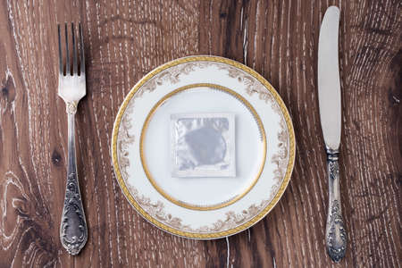 condom in a plate on the tableの写真素材