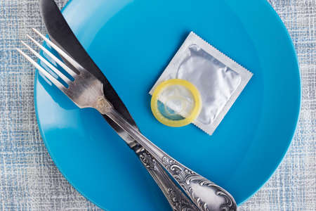condom in a plate on the tableの写真素材