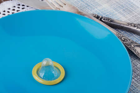 condom in a plate on the tableの写真素材