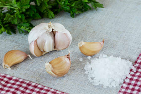head of garlic and sea salt on the tableの写真素材