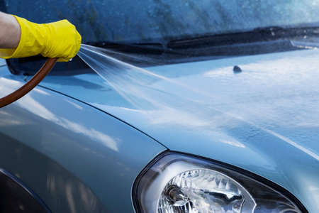 blue car is washing in soap sudsの写真素材