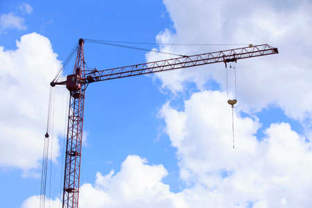 the construction crane on a background sky
