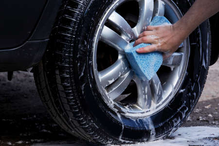 car wheel is washing in soap sudsの写真素材