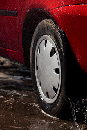 car wheel is washing in soap sudsの写真素材