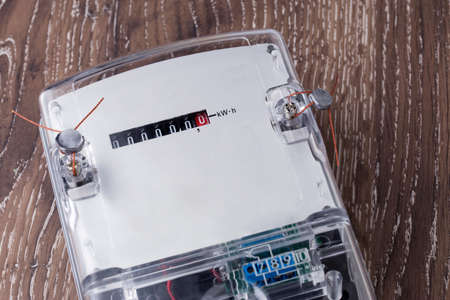 the electric meter on a wooden wallの写真素材