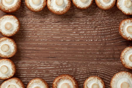the raw royal mushrooms on a wooden table