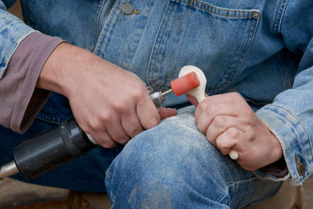 the carpenter grinds the block of woodの写真素材
