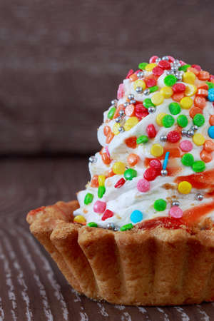 the colorful cupcakes on a wooden background
