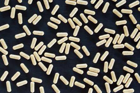 the medical pills on a black background