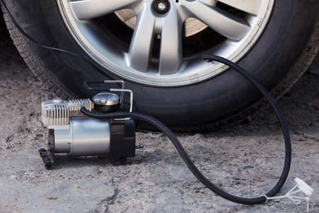 inflating the automobile wheels via a pumpの写真素材