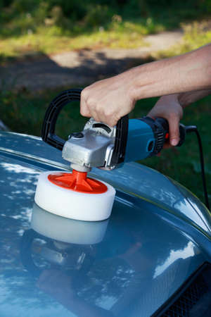 blue car is polishing on open air