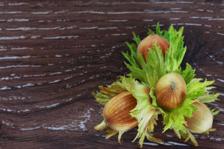 the handful of hazelnuts on a wooden tableの写真素材