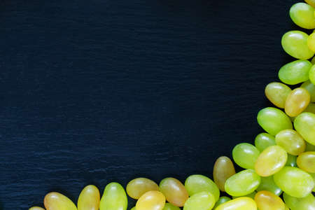 the bunch of grapes on a black background